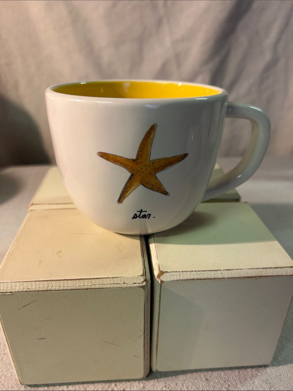 Rae Dunn White Ceramic Mug with Yellow Interior and Starfish